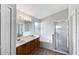 Bright bathroom featuring dual sinks, a garden tub, and a glass-enclosed shower at 332 Lake Doe Blvd, Apopka, FL 32703