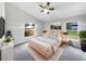Bright bedroom features a ceiling fan, neutral walls, and natural light from the two windows at 332 Lake Doe Blvd, Apopka, FL 32703