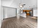 Living room featuring wood flooring, neutral walls, and an open layout with a kitchen view at 332 Lake Doe Blvd, Apopka, FL 32703