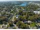 Aerial view of the neighborhood showcasing tree-lined streets and nearby lake at 342 Oak Estates Dr, Orlando, FL 32806