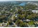 Lushly landscaped property featuring mature trees and a serene lake view in a desirable neighborhood setting at 342 Oak Estates Dr, Orlando, FL 32806