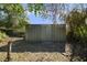 Metal storage shed in backyard, surrounded by trees and foliage at 342 Oak Estates Dr, Orlando, FL 32806