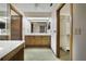 Bathroom with double vanity, mirrored wall, and access to the walk-in closet at 342 Oak Estates Dr, Orlando, FL 32806