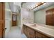 Bathroom featuring a large mirror, wooden cabinets, and tiled floors at 342 Oak Estates Dr, Orlando, FL 32806