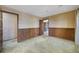 Spacious bedroom with wainscoting, wall paper, and access to an adjacent room at 342 Oak Estates Dr, Orlando, FL 32806