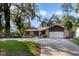 Charming single-story home with stone accents, mature landscaping, and an attached two-car garage at 342 Oak Estates Dr, Orlando, FL 32806