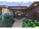 Inviting entryway with wood double doors, stone accents, and lush landscaping at 342 Oak Estates Dr, Orlando, FL 32806