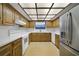 Well-lit kitchen with light countertops, oak cabinets and stainless steel refrigerator at 342 Oak Estates Dr, Orlando, FL 32806