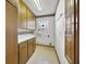 Compact laundry room with ample cabinets and a practical utility sink for added convenience at 342 Oak Estates Dr, Orlando, FL 32806