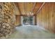 Spacious living room featuring a stone wall, wood paneled walls and ceiling with a modern chandelier at 342 Oak Estates Dr, Orlando, FL 32806