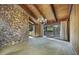 Spacious living room with vaulted wood ceilings, stone fireplace, and backyard access at 342 Oak Estates Dr, Orlando, FL 32806