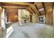 Open living room with vaulted wood ceilings, stone fireplace, and backyard access at 342 Oak Estates Dr, Orlando, FL 32806