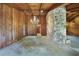Large living room with a stone accent wall, wood paneling, and a unique modern light fixture at 342 Oak Estates Dr, Orlando, FL 32806