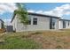 The backyard features a newly planted tree and access to a sliding glass door at 3876 Giorgio Dr, Winter Haven, FL 33884
