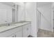 Bathroom featuring double vanity with granite counters and a glass-enclosed shower at 3876 Giorgio Dr, Winter Haven, FL 33884