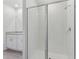 Bright bathroom with glass-enclosed shower and vanity with white cabinets and light countertop at 3876 Giorgio Dr, Winter Haven, FL 33884