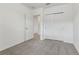 A cozy bedroom features neutral carpet, closet doors, and access to an adjoining room at 3876 Giorgio Dr, Winter Haven, FL 33884