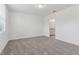 Bright bedroom with neutral carpet and an open doorway to the ensuite bathroom at 3876 Giorgio Dr, Winter Haven, FL 33884
