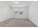Bright bedroom featuring neutral carpet, two windows, and a door leading to an adjoining room at 3876 Giorgio Dr, Winter Haven, FL 33884