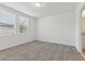 Well-lit bedroom with two windows and neutral carpet flooring, leading to the ensuite at 3876 Giorgio Dr, Winter Haven, FL 33884