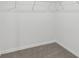 Walk-in closet with neutral carpeting and wire shelving ready for storage and organization at 3876 Giorgio Dr, Winter Haven, FL 33884