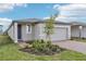 Charming one-story home with a two-car garage, brick driveway, and beautiful landscaping at 3876 Giorgio Dr, Winter Haven, FL 33884