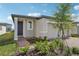 Welcoming one-story home with a two-car garage, a brick walkway, and fresh landscaping at 3876 Giorgio Dr, Winter Haven, FL 33884