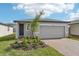 Charming one-story home with a two-car garage, brick driveway, and manicured landscaping at 3876 Giorgio Dr, Winter Haven, FL 33884