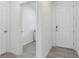 Hallway with tile floors leading to laundry room and main door at 3876 Giorgio Dr, Winter Haven, FL 33884