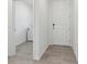 Hallway with tile floors leading to laundry room and main door at 3876 Giorgio Dr, Winter Haven, FL 33884