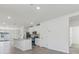 Bright kitchen features a center island, stainless steel appliances, and white cabinets at 3876 Giorgio Dr, Winter Haven, FL 33884