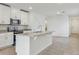 Modern kitchen features a center island with sink and stainless-steel appliances at 3876 Giorgio Dr, Winter Haven, FL 33884