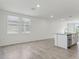 Modern kitchen with stainless steel appliances, granite countertops and gray tiled floor at 3876 Giorgio Dr, Winter Haven, FL 33884