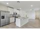 Open-concept kitchen with stainless steel appliances, island, and ample counter space at 3876 Giorgio Dr, Winter Haven, FL 33884