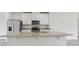 Close up of kitchen island with stainless steel appliances and granite countertops at 3876 Giorgio Dr, Winter Haven, FL 33884