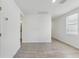 Bright living room featuring gray tiled floor and a window with modern blinds at 3876 Giorgio Dr, Winter Haven, FL 33884
