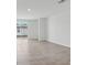 Open living area with tile flooring and sliding glass door leading to the backyard at 3876 Giorgio Dr, Winter Haven, FL 33884