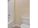 Well-lit bathroom featuring tiled bathtub and toilet at 39 Hickory Course Way, Ocala, FL 34472