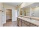 Bright bathroom featuring a double vanity, granite counters, and walk-in shower at 39 Hickory Course Way, Ocala, FL 34472