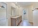 Bathroom with double sink vanity, tile floors, and entry to walk in closet and bedroom at 39 Hickory Course Way, Ocala, FL 34472