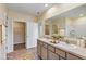 Bathroom featuring a double vanity with granite counters and separate walk-in closet at 39 Hickory Course Way, Ocala, FL 34472