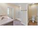 Bright bathroom featuring a double vanity, tile flooring, standing shower, and toilet at 39 Hickory Course Way, Ocala, FL 34472