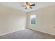 Bedroom with neutral walls, carpeted floor, ceiling fan, and window at 39 Hickory Course Way, Ocala, FL 34472