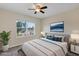 Relaxing bedroom featuring a queen bed, ceiling fan, and serene neighborhood views at 39 Hickory Course Way, Ocala, FL 34472