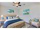 Charming bedroom with wicker accents, coastal artwork, and a comfortable seating area at 39 Hickory Course Way, Ocala, FL 34472