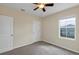 Bedroom with neutral walls, carpeted floor, ceiling fan, and window at 39 Hickory Course Way, Ocala, FL 34472