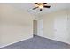 Bedroom featuring a ceiling fan and two closet doors at 39 Hickory Course Way, Ocala, FL 34472