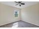 Cozy bedroom features a ceiling fan, neutral paint, and a bright window overlooking the outdoors at 39 Hickory Course Way, Ocala, FL 34472