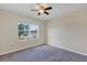Bedroom features a window with view and ceiling fan at 39 Hickory Course Way, Ocala, FL 34472