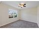 Cozy bedroom featuring new carpet, a ceiling fan, and a bright window at 39 Hickory Course Way, Ocala, FL 34472